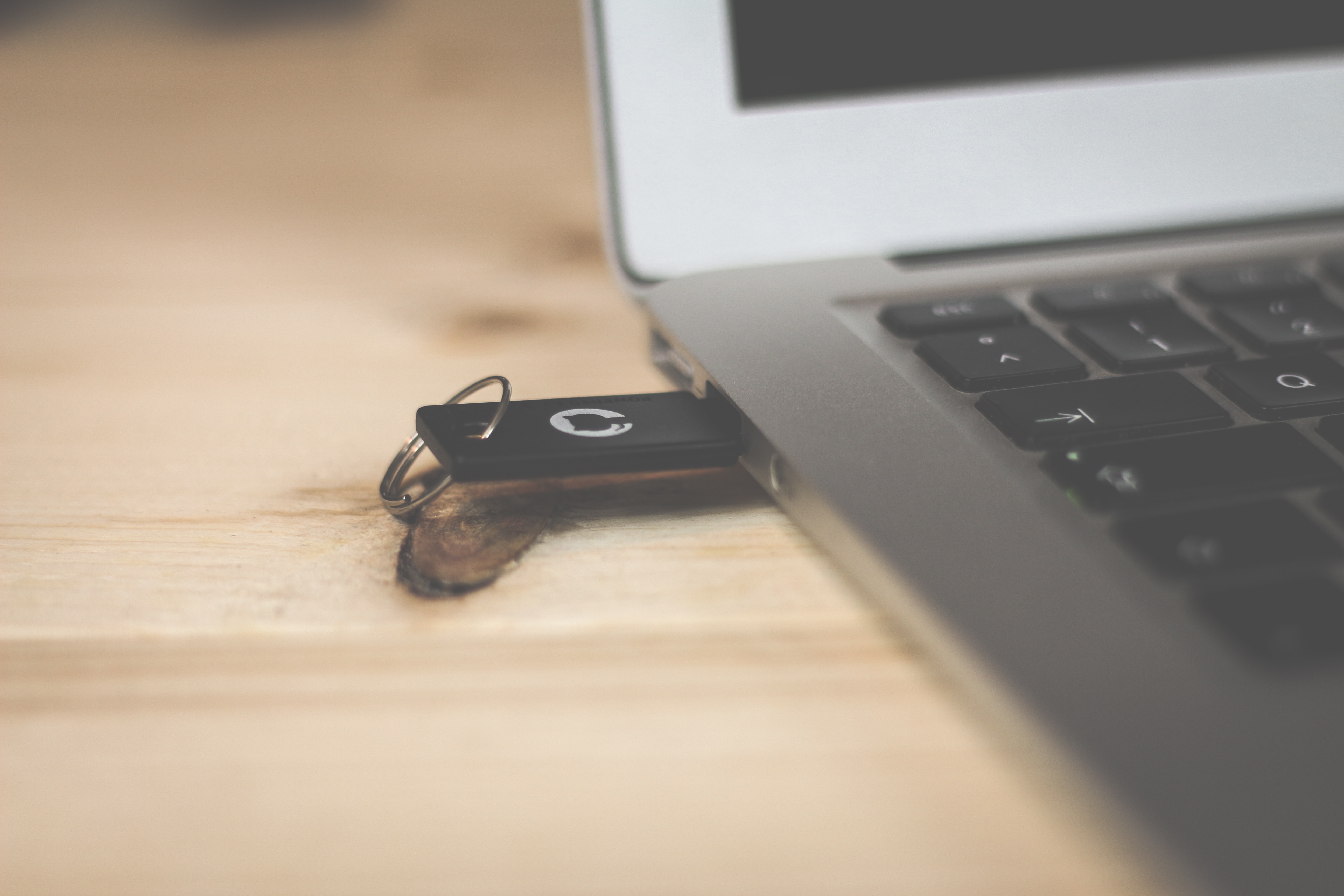 Laptop with USB stick. Photo by Brina Blum on Unsplash